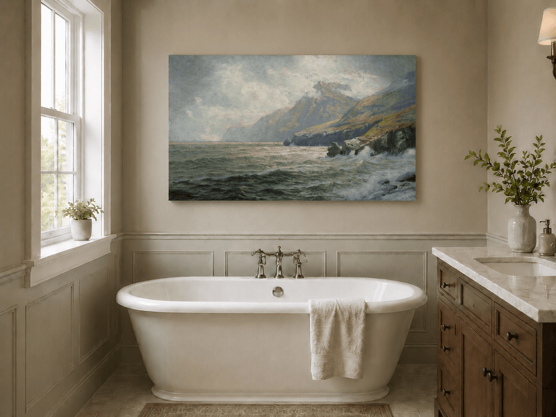 Unframed hand-painted coastal mountain oil painting with waves breaking on a rocky shore displayed above a freestanding bathtub.