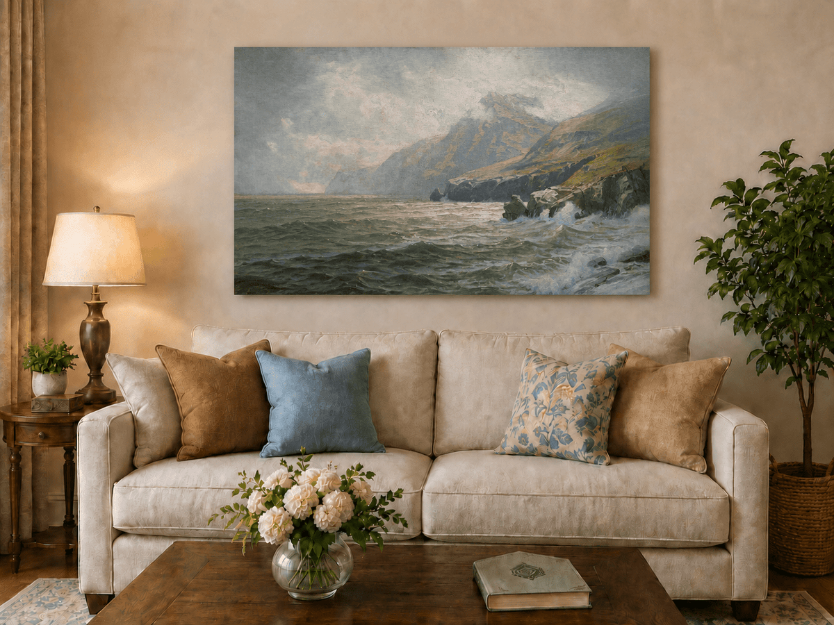Unframed hand-painted coastal mountain oil painting with waves breaking on a rocky shore displayed above a neutral living room sofa.