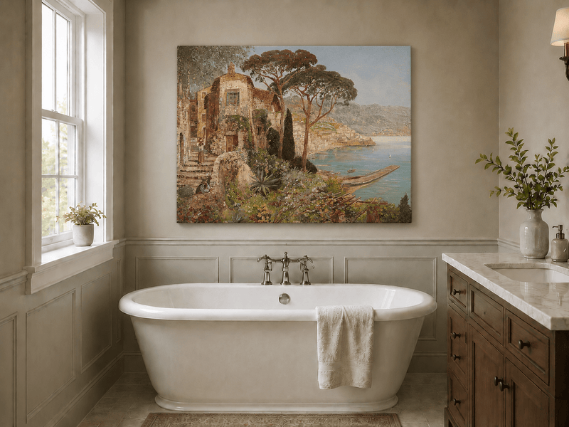 Unframed hand-painted coastal village oil painting with flowers and blue sea displayed above a freestanding bathtub.