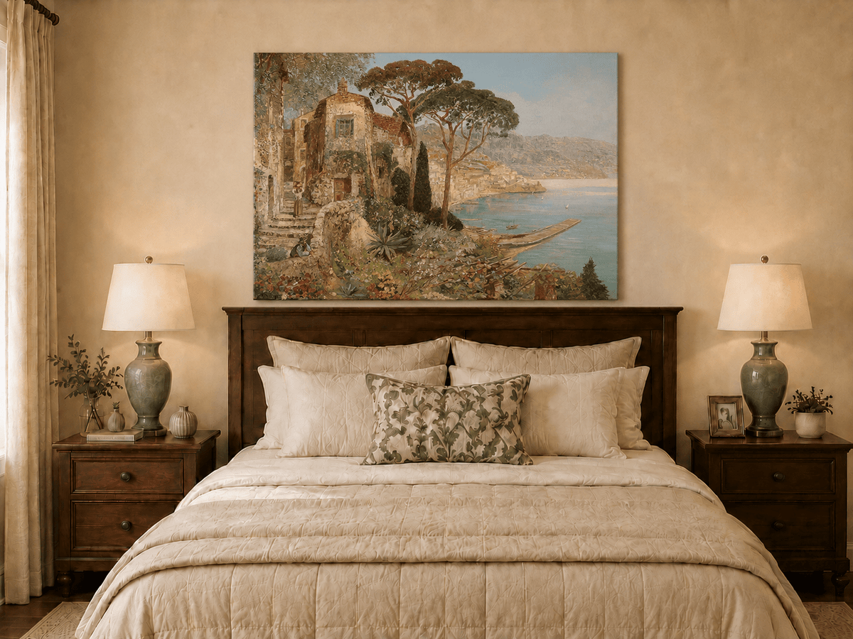 Unframed hand-painted coastal village oil painting with flowers and blue sea displayed above a wooden bed in a neutral bedroom.