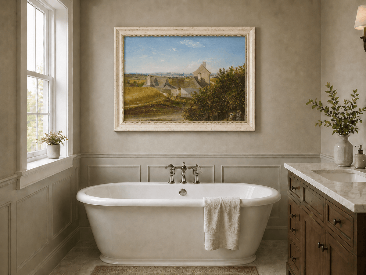 Framed hand-painted country houses oil painting with a winding road and distant city view displayed above a freestanding bathtub.