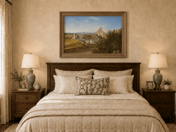 Framed hand-painted country houses oil painting with a winding road and distant city view displayed above a wooden bed in a neutral bedroom.