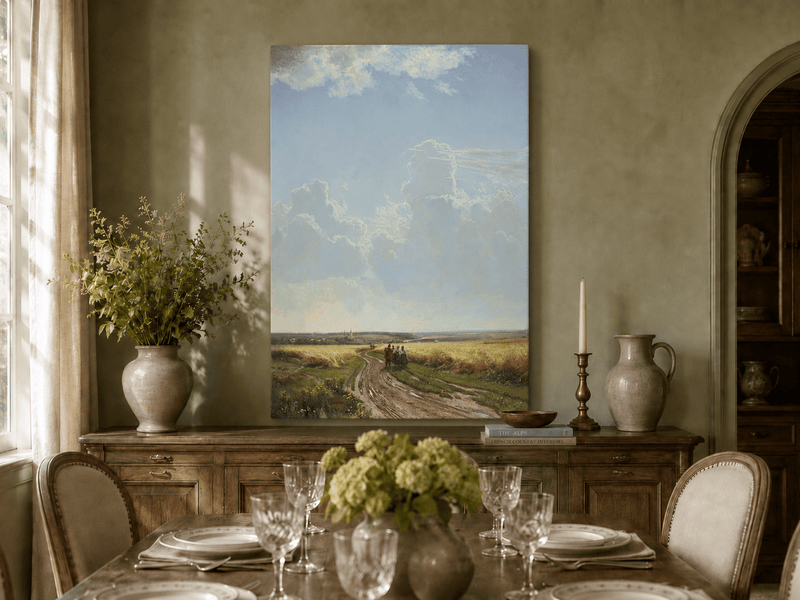 Unframed hand-painted countryside oil painting with a road through wheat fields beneath broad clouds displayed above a formal dining table.