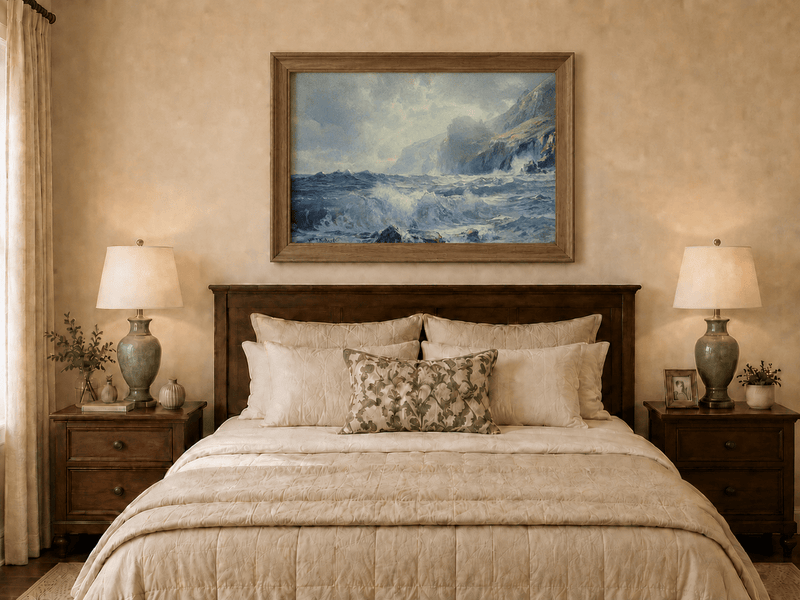 Framed hand-painted seascape oil painting with crashing waves along a rocky coastal shore displayed above a wooden bed in a neutral bedroom.