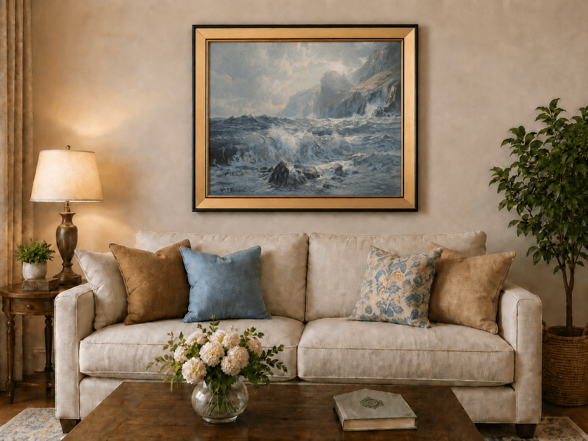 Framed hand-painted seascape oil painting with crashing waves along a rocky coastal shore displayed above a neutral living room sofa.