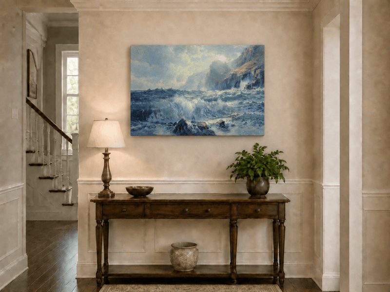 Unframed hand-painted seascape oil painting with crashing waves along a rocky coastal shore displayed above an entryway console table.
