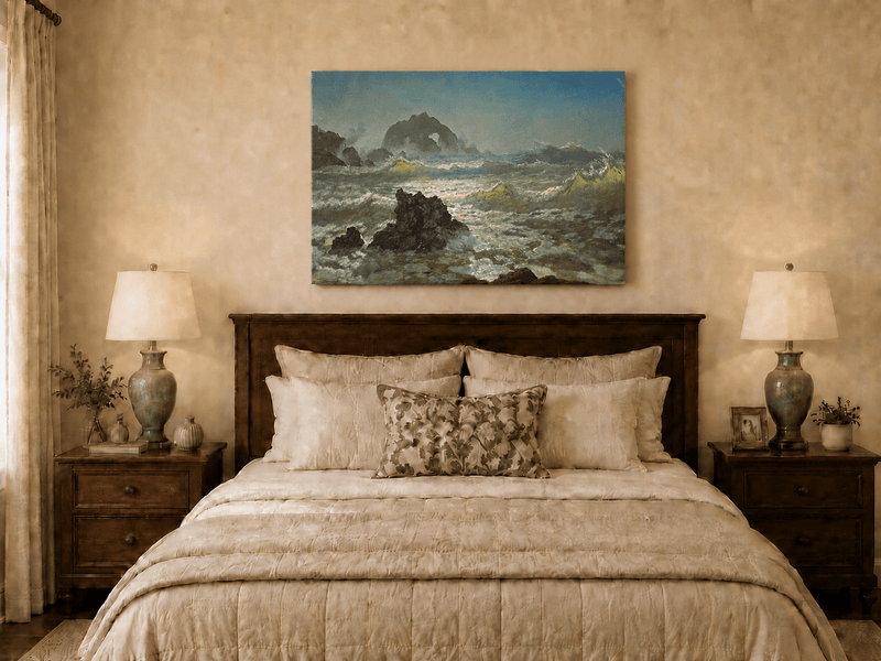 Unframed hand-painted seascape oil painting with crashing waves and a rocky sea arch displayed above a wooden bed in a neutral bedroom.