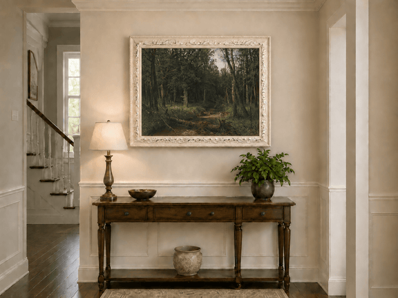 Framed hand-painted dense forest path oil painting with shadowed trees and fallen branches displayed above an entryway console table.