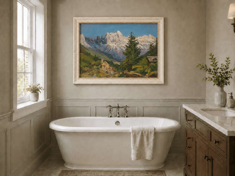 Framed hand-painted Dolomite village oil painting beneath dramatic alpine peaks displayed above a freestanding bathtub.