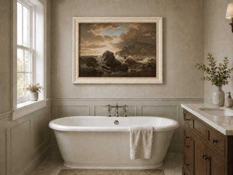 Framed hand-painted dramatic coastal seascape with crashing waves and dark rocks displayed above a freestanding bathtub.