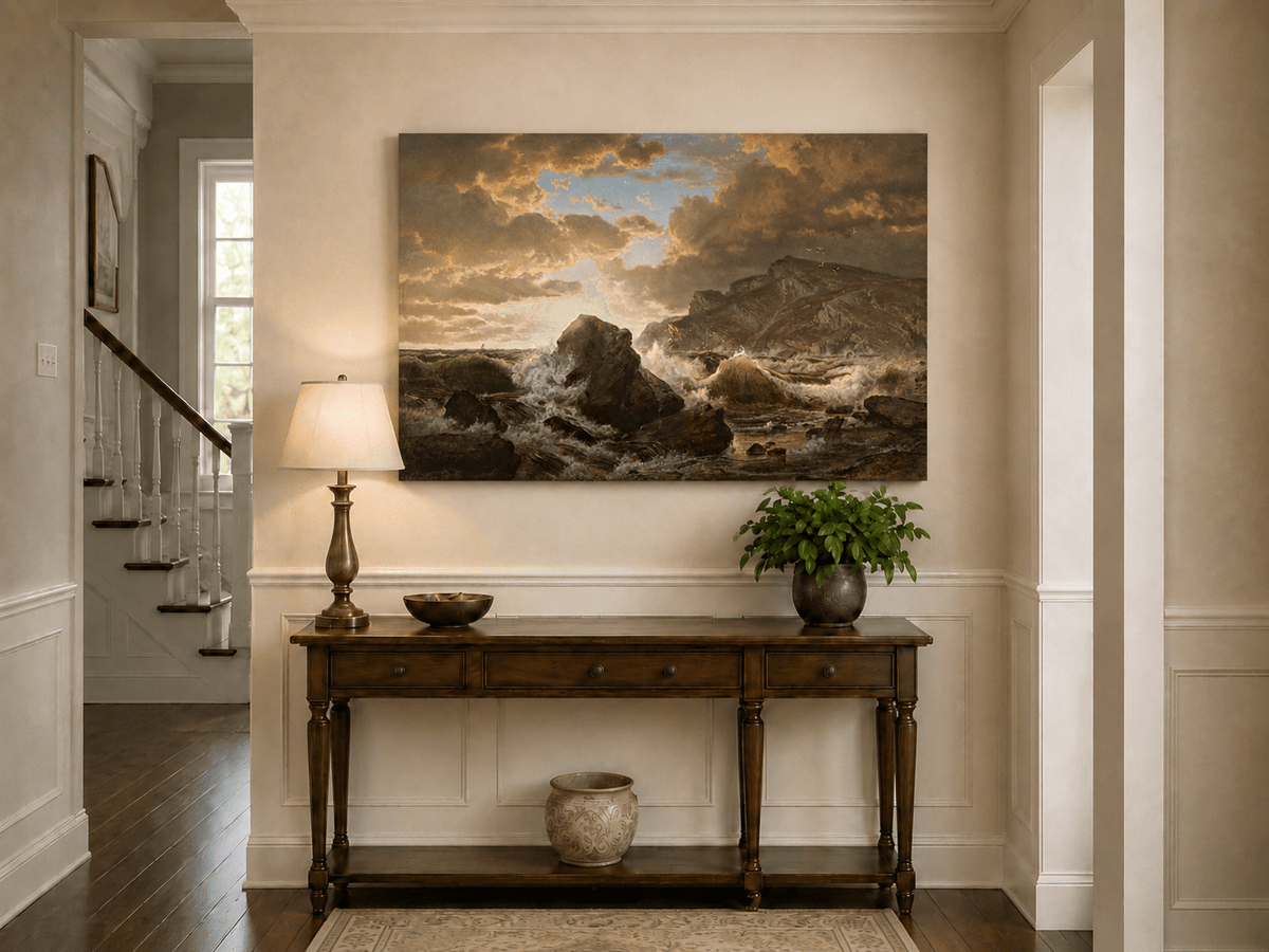Unframed hand-painted dramatic coastal seascape with crashing waves and dark rocks displayed above an entryway console table.