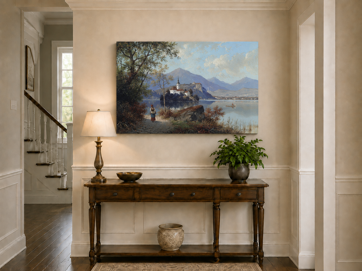 Hand-painted European lakeside village landscape oil painting displayed above a console table in a hallway interior.