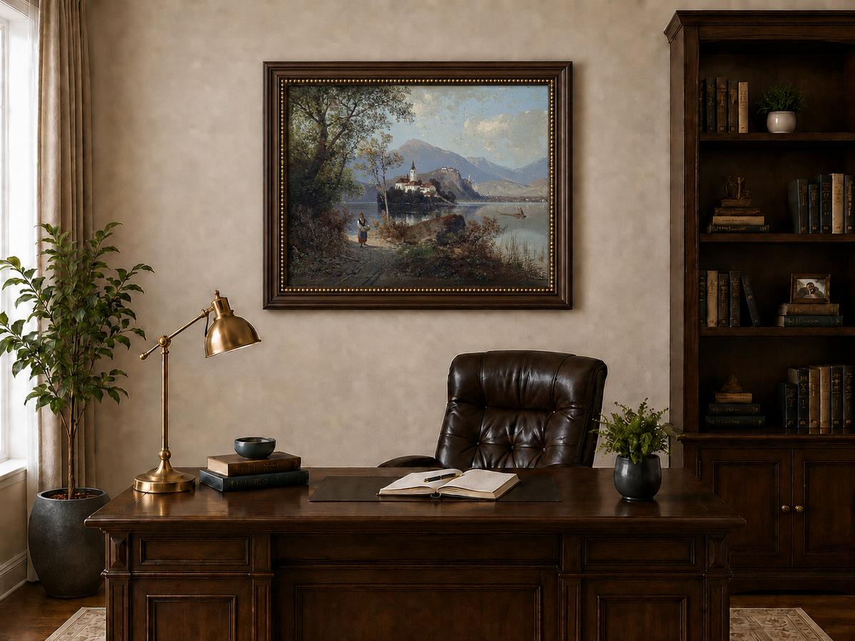 Hand-painted European lakeside village landscape oil painting displayed above a desk in a home office interior.