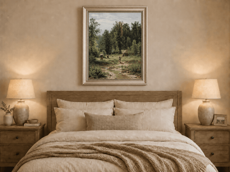 Framed hand-painted forest cottage oil painting with a stream, path and walking figure displayed above a wooden bed in a neutral bedroom.