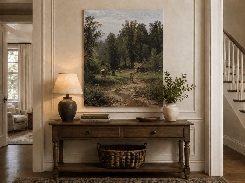 Unframed hand-painted forest cottage oil painting with a stream, path and walking figure displayed above an entryway console table.