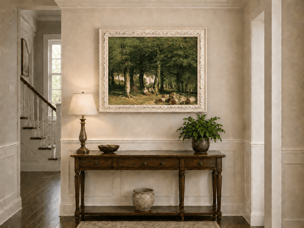 Framed hand-painted forest oil painting with figures resting near cut logs and tall trees displayed above an entryway console table.