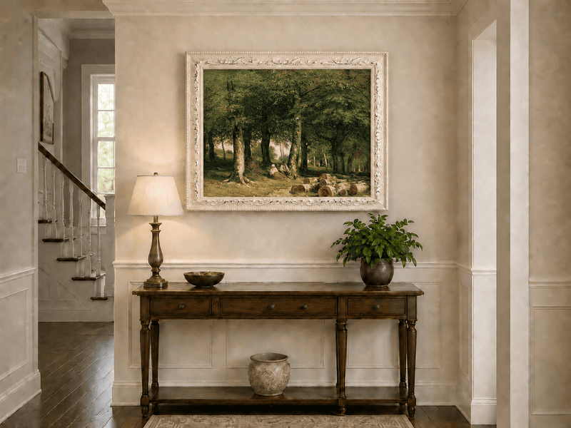 Framed hand-painted forest oil painting with figures resting near cut logs and tall trees displayed above an entryway console table.