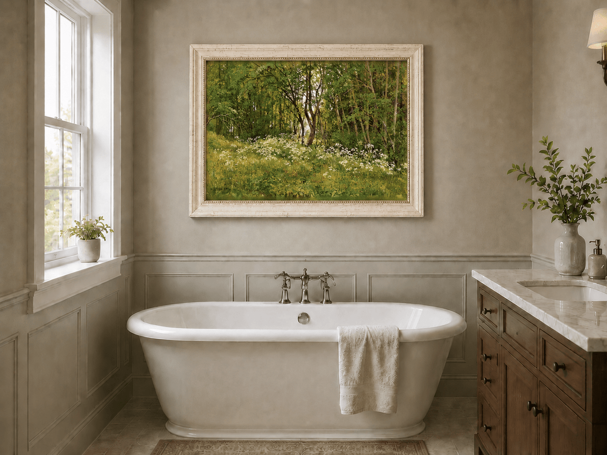 Framed hand-painted forest glade oil painting with wildflowers and tall trees displayed above a freestanding bathtub.