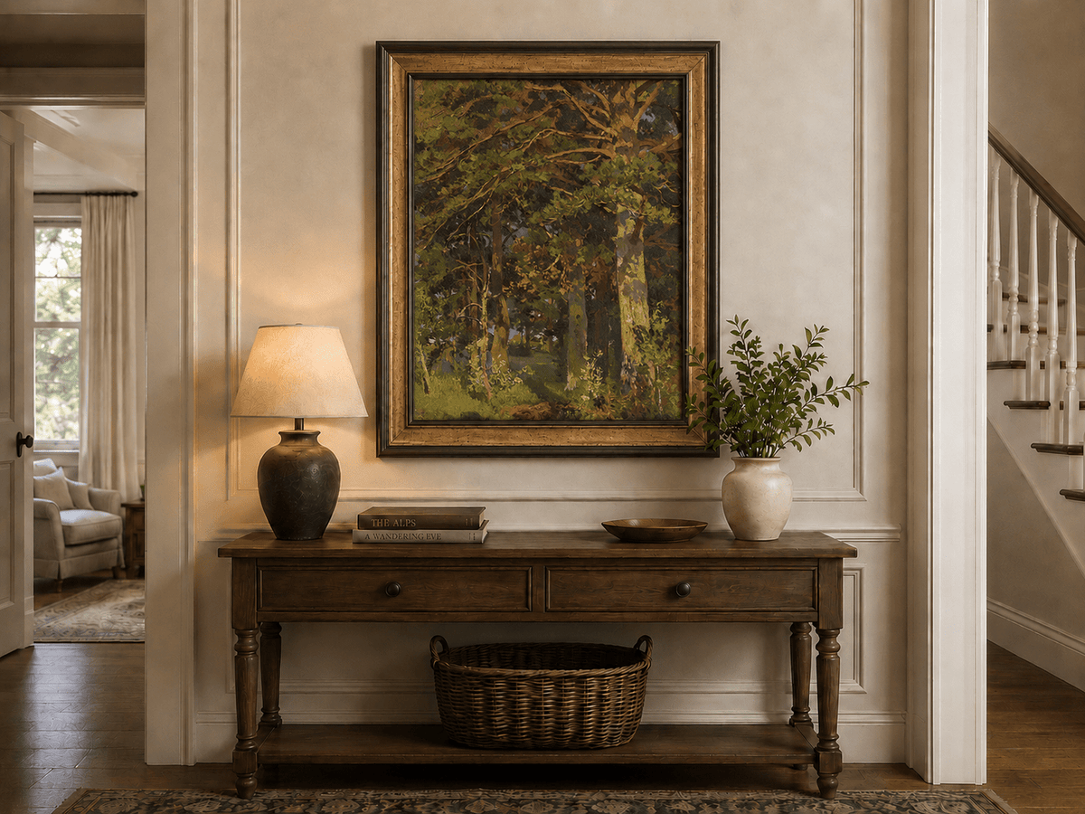 Framed hand-painted forest interior oil painting with sunlit autumn trees and foliage displayed above an entryway console table.