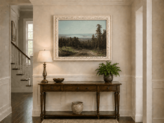 Framed hand-painted forest path oil painting leading toward a distant lake displayed above an entryway console table.
