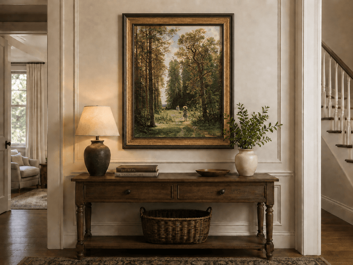 Framed hand-painted forest path oil painting with figures beneath autumn trees displayed above an entryway console table.