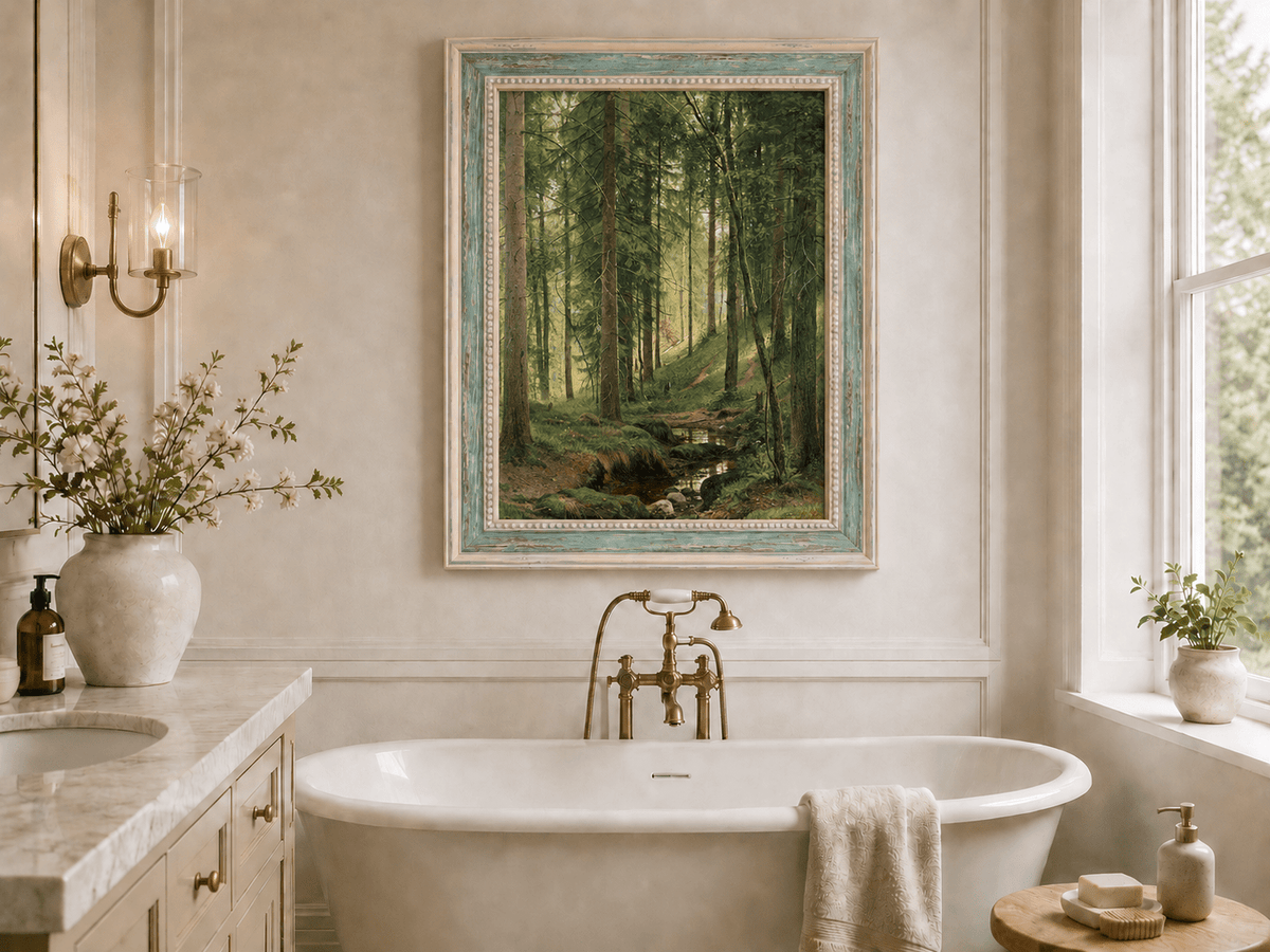 Framed hand-painted forest path oil painting with a quiet stream and fallen woodland logs displayed above a freestanding bathtub.
