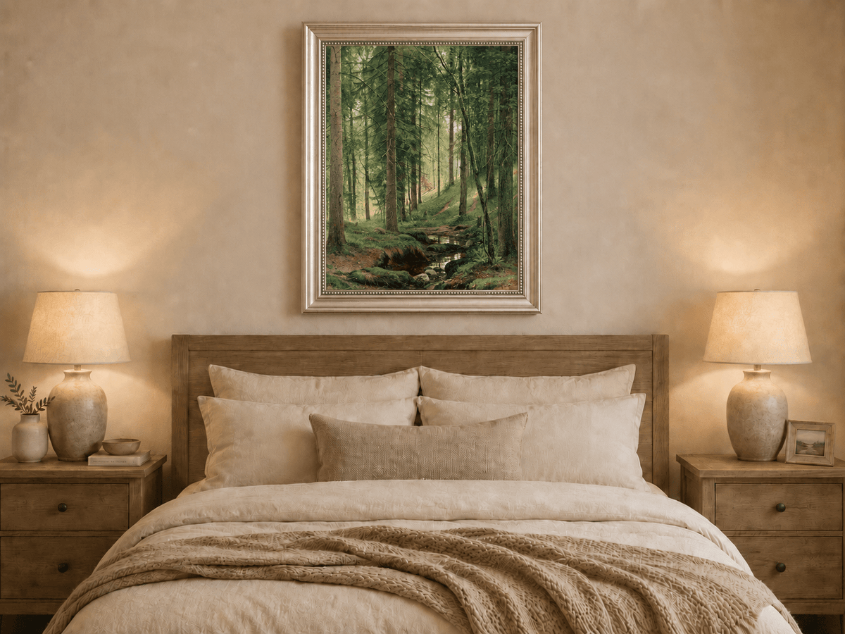 Framed hand-painted forest path oil painting with a quiet stream and fallen woodland logs displayed above a wooden bed in a neutral bedroom.