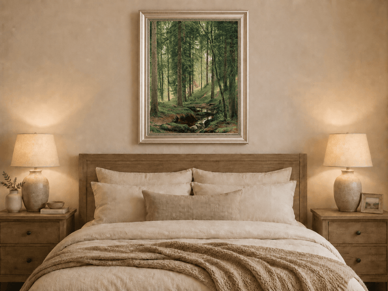 Framed hand-painted forest path oil painting with a quiet stream and fallen woodland logs displayed above a wooden bed in a neutral bedroom.