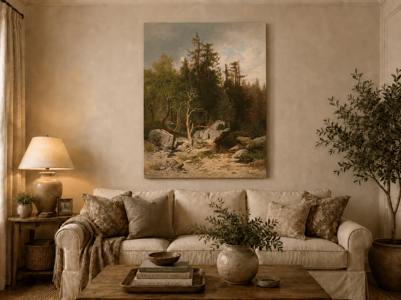 Unframed hand-painted forest oil painting with rocks, a creek and a gnarled old tree displayed above a neutral living room sofa.