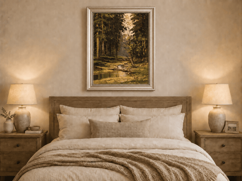Framed hand-painted forest stream oil painting with tall trees and warm filtered light displayed above a wooden bed in a neutral bedroom.