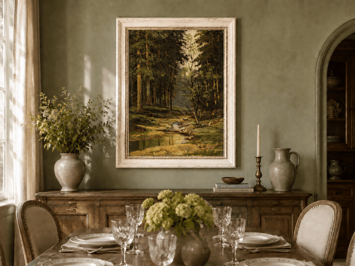 Framed hand-painted forest stream oil painting with tall trees and warm filtered light displayed above a formal dining table.