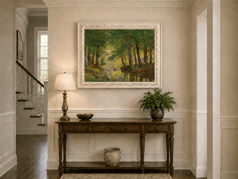 Framed hand-painted forest stream oil painting with tall trees and bright reflections displayed above an entryway console table.