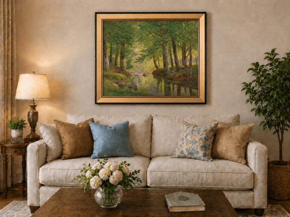 Framed hand-painted forest stream oil painting with tall trees and bright reflections displayed above a neutral living room sofa.