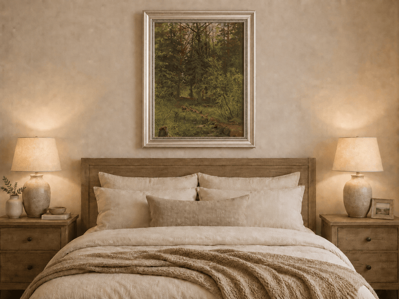 Framed hand-painted woodland stream oil painting with dense trees and shadowed water displayed above a wooden bed in a neutral bedroom.