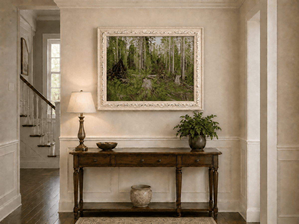 Framed hand-painted forest floor oil painting with tree stumps, ferns and slender birches displayed above an entryway console table.