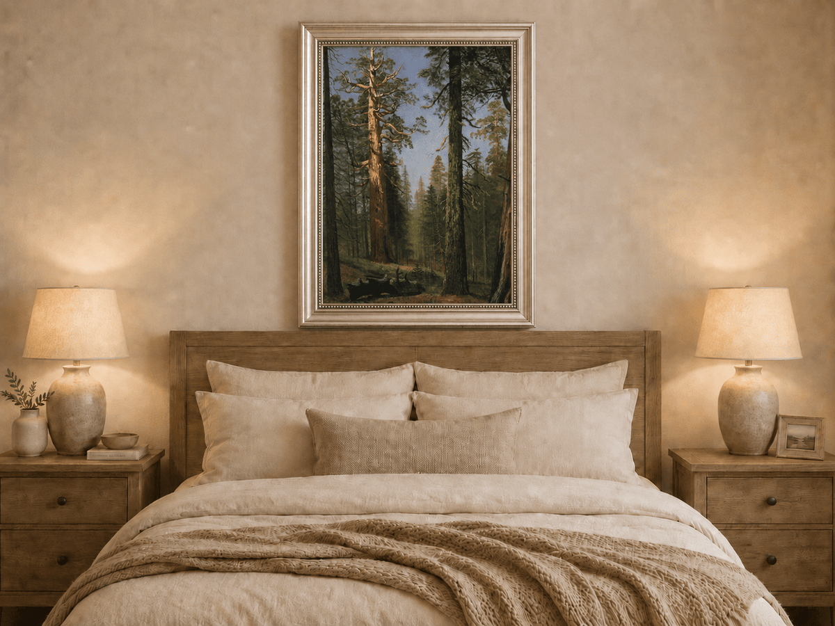 Framed hand-painted giant sequoia forest oil painting with towering trees and sunlight displayed above a wooden bed in a neutral bedroom.