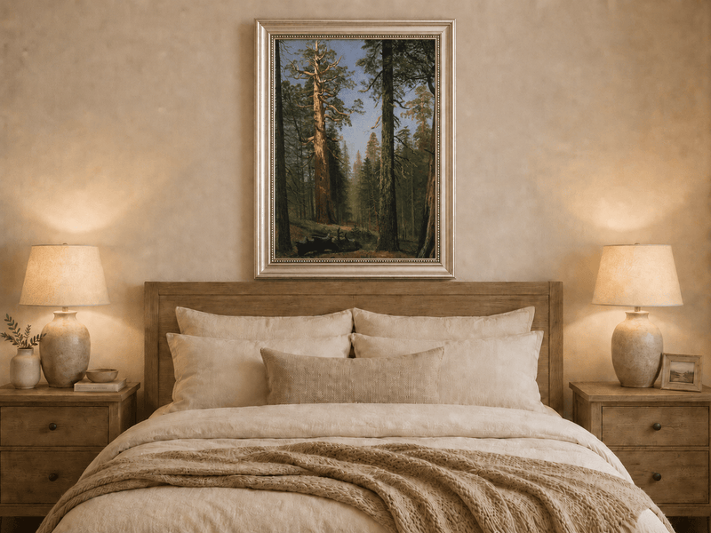 Framed hand-painted giant sequoia forest oil painting with towering trees and sunlight displayed above a wooden bed in a neutral bedroom.