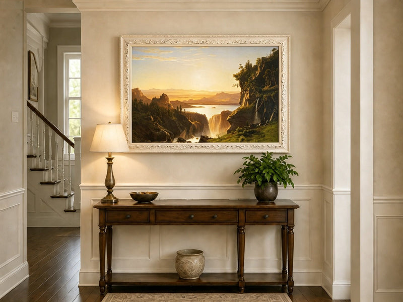 Framed hand-painted golden canyon oil painting with a lake and distant waterfall displayed above an entryway console table.