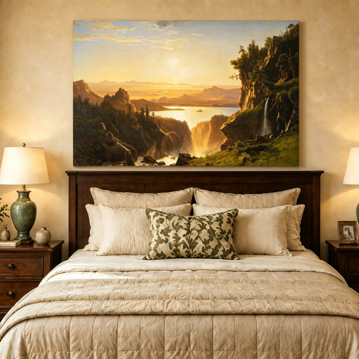 Unframed hand-painted golden canyon oil painting with a lake and distant waterfall displayed above a wooden bed in a neutral bedroom.
