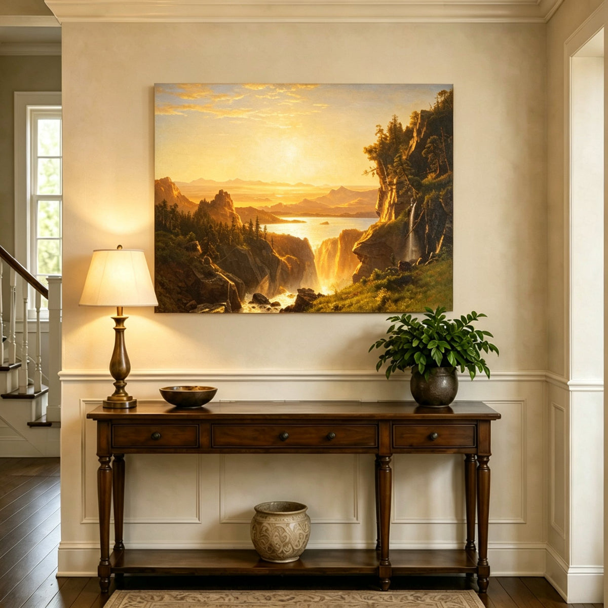 Unframed hand-painted golden canyon oil painting with a lake and distant waterfall displayed above an entryway console table.