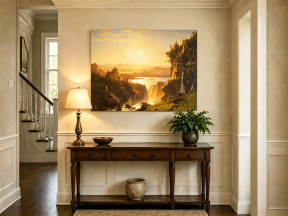 Unframed hand-painted golden canyon oil painting with a lake and distant waterfall displayed above an entryway console table.