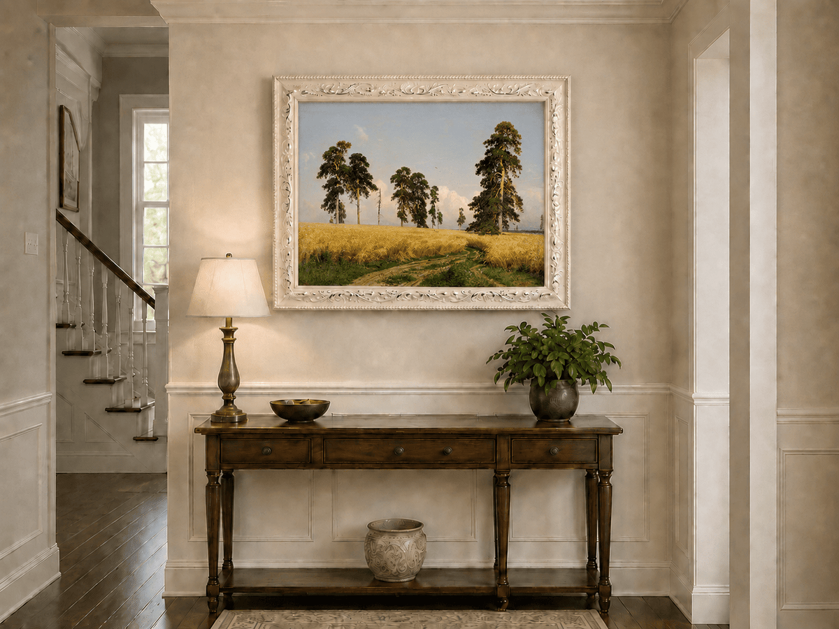 Framed hand-painted golden wheat field oil painting with pine trees and a country path displayed above an entryway console table.