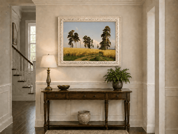 Framed hand-painted golden wheat field oil painting with pine trees and a country path displayed above an entryway console table.