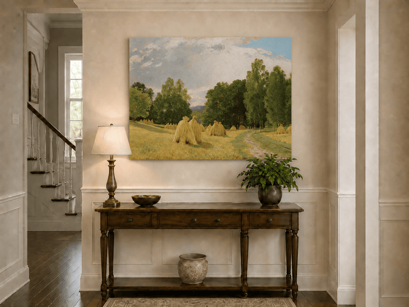Unframed hand-painted harvest field oil painting with haystacks and a tree-lined path displayed above an entryway console table.