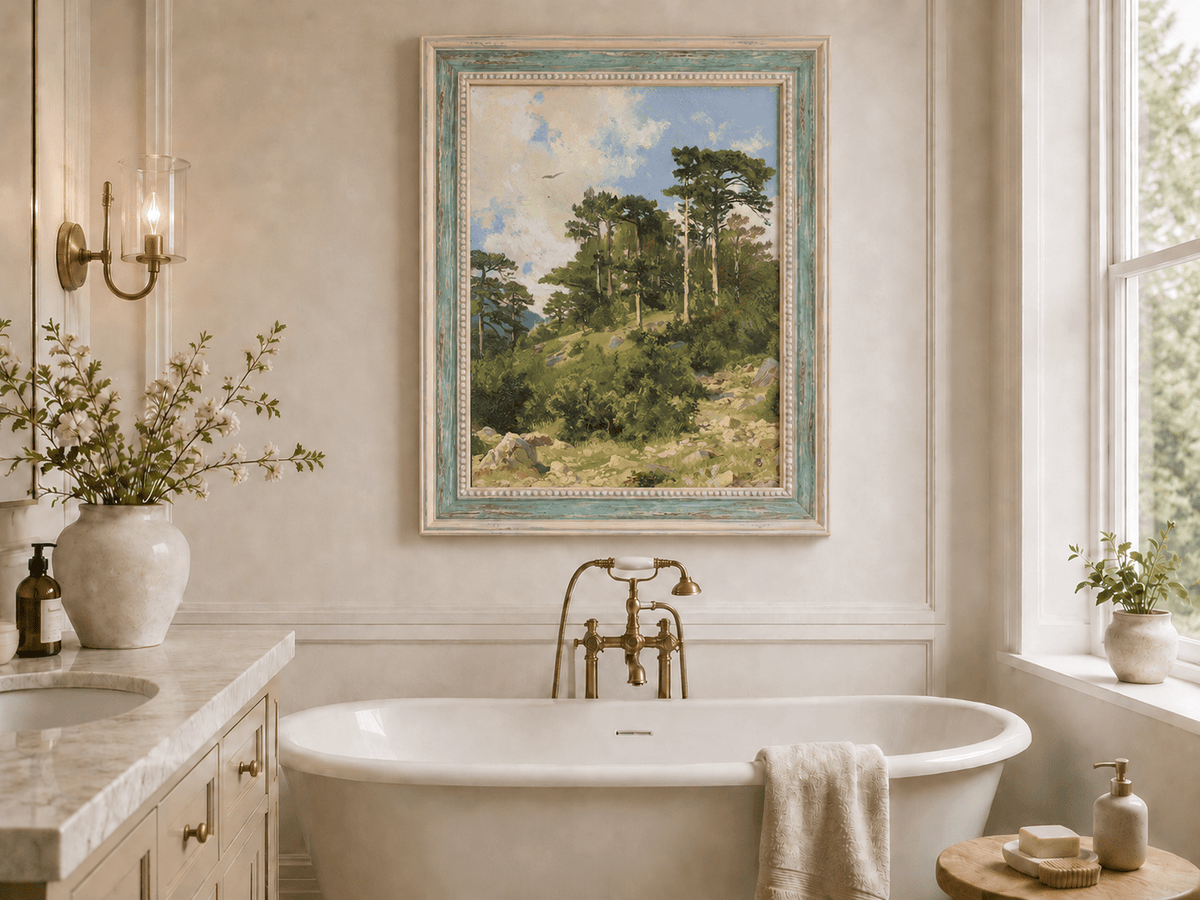 Framed hand-painted hillside oil painting with pine trees, rocks and open sky displayed above a freestanding bathtub.