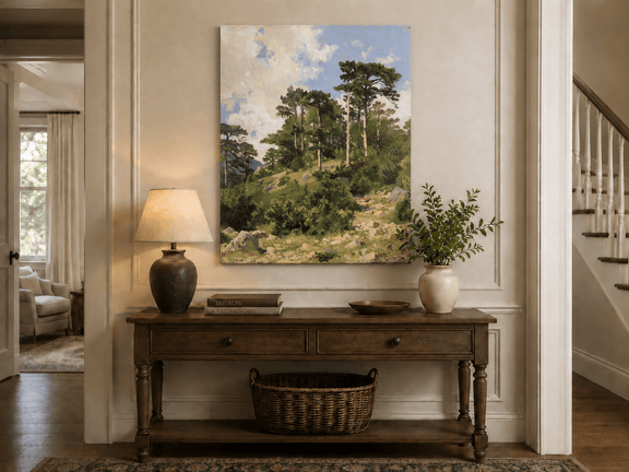 Unframed hand-painted hillside oil painting with pine trees, rocks and open sky displayed above an entryway console table.
