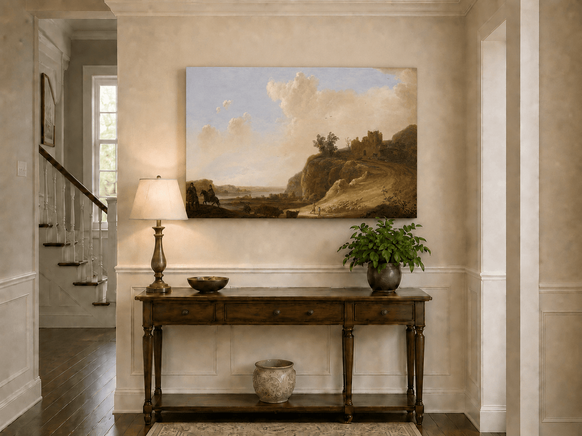 Unframed hand-painted landscape oil painting with hilltop ruins, figures and a winding road displayed above an entryway console table.