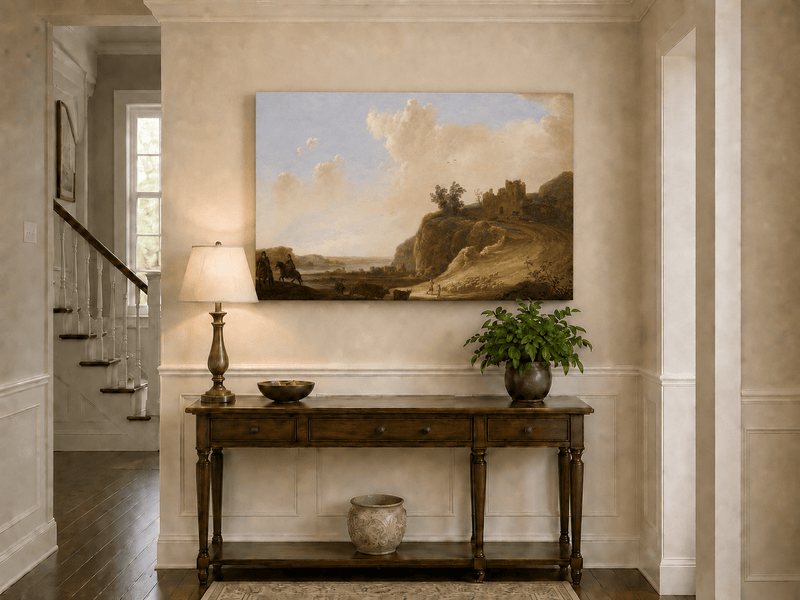 Unframed hand-painted landscape oil painting with hilltop ruins, figures and a winding road displayed above an entryway console table.