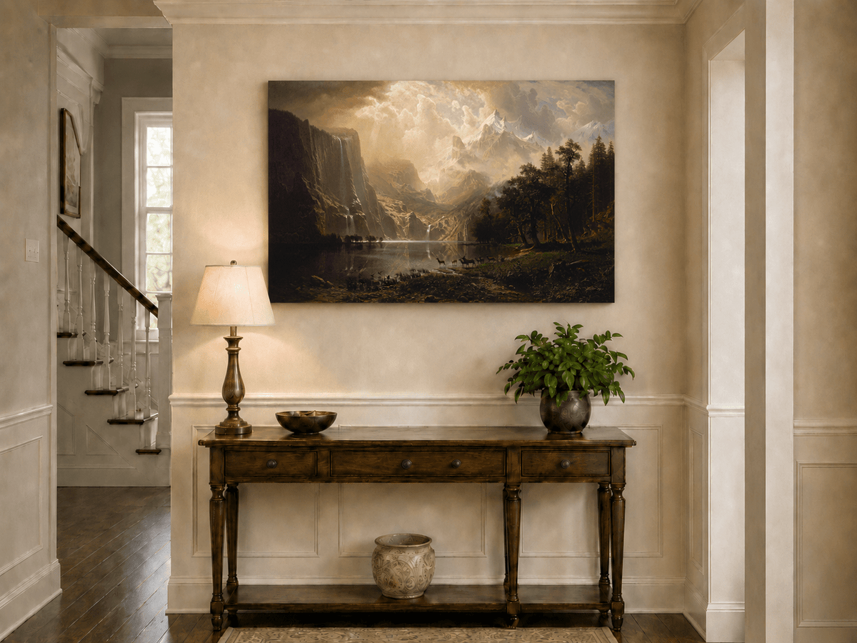 Unframed hand-painted mountain stream oil painting with dramatic holy light breaking through clouds displayed above an entryway console table.