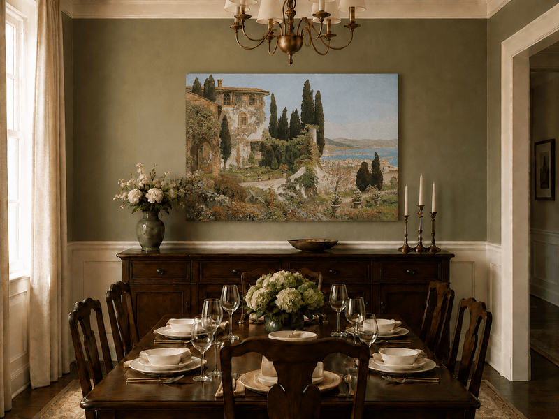 Unframed hand-painted Italian garden oil painting with cypress trees overlooking the sea displayed above a formal dining table.